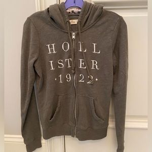 Dark olive green hollister zip up jacket with floral design on hood
